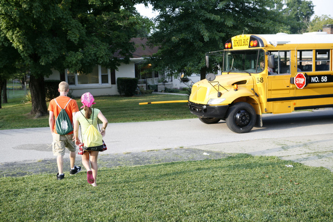 Students walking toward a school bus.