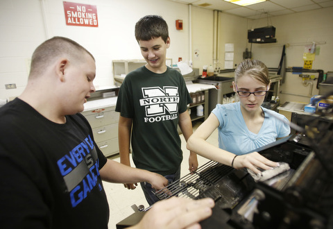 Students work on a printing press
