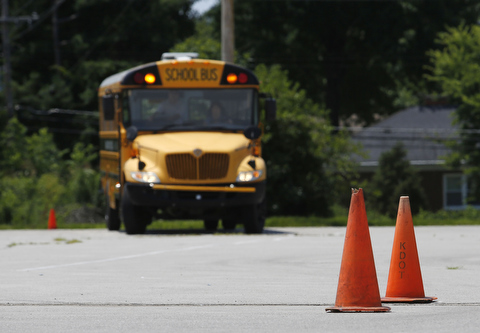 Photo of a school bus on during going through an obstacle course during training.